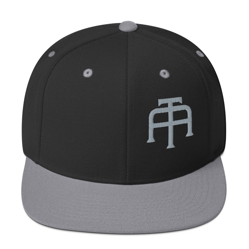 An Athlete Trains structured hat with a classic fit, flat brim, full buckram, and adjustable snap closure.