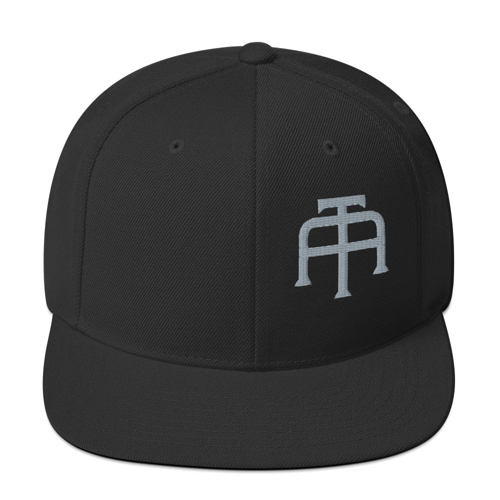 An Athlete Trains structured hat with a classic fit, flat brim, full buckram, and adjustable snap closure.