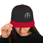 An Athlete Trains structured hat with a classic fit, flat brim, full buckram, and adjustable snap closure.