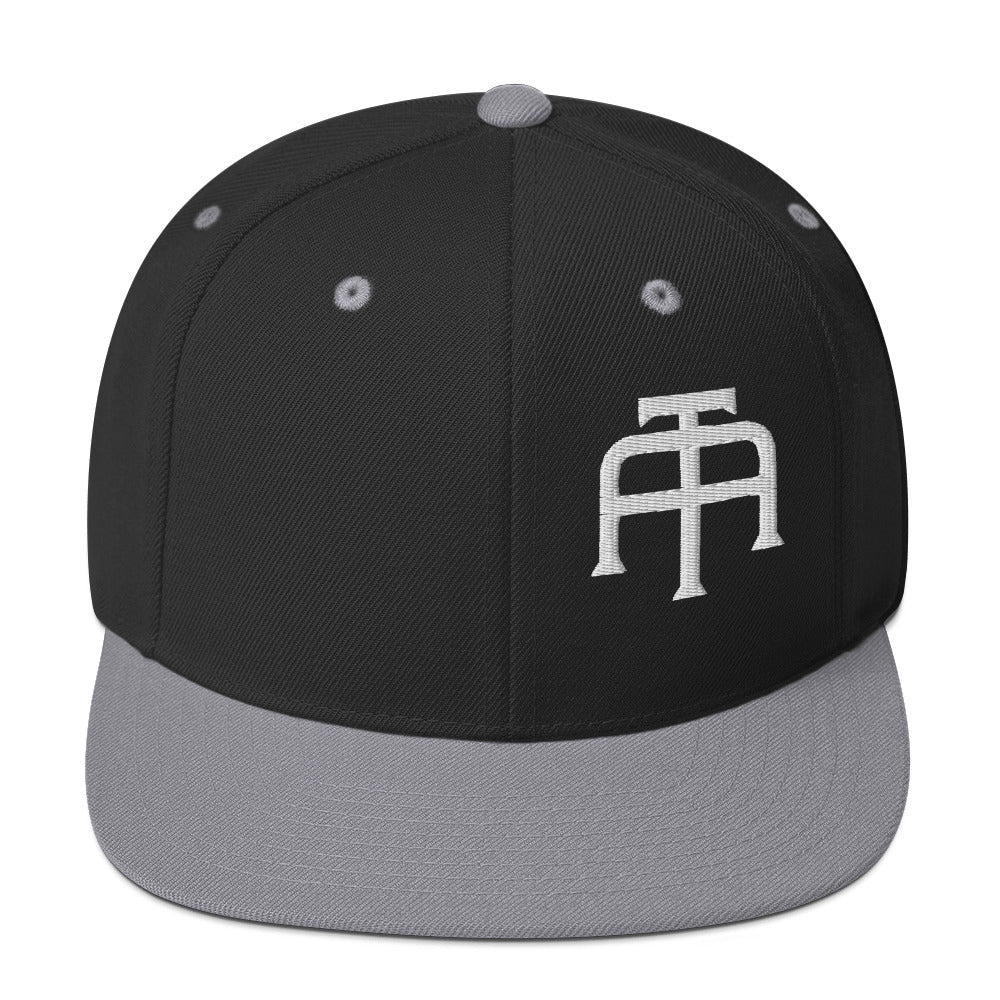 An Athlete Trains structured hat with a classic fit, flat brim, full buckram, and adjustable snap closure.