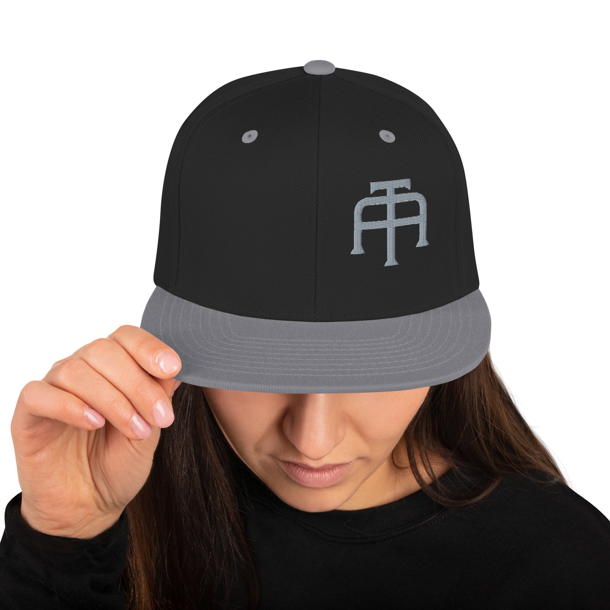 An Athlete Trains structured hat with a classic fit, flat brim, full buckram, and adjustable snap closure.