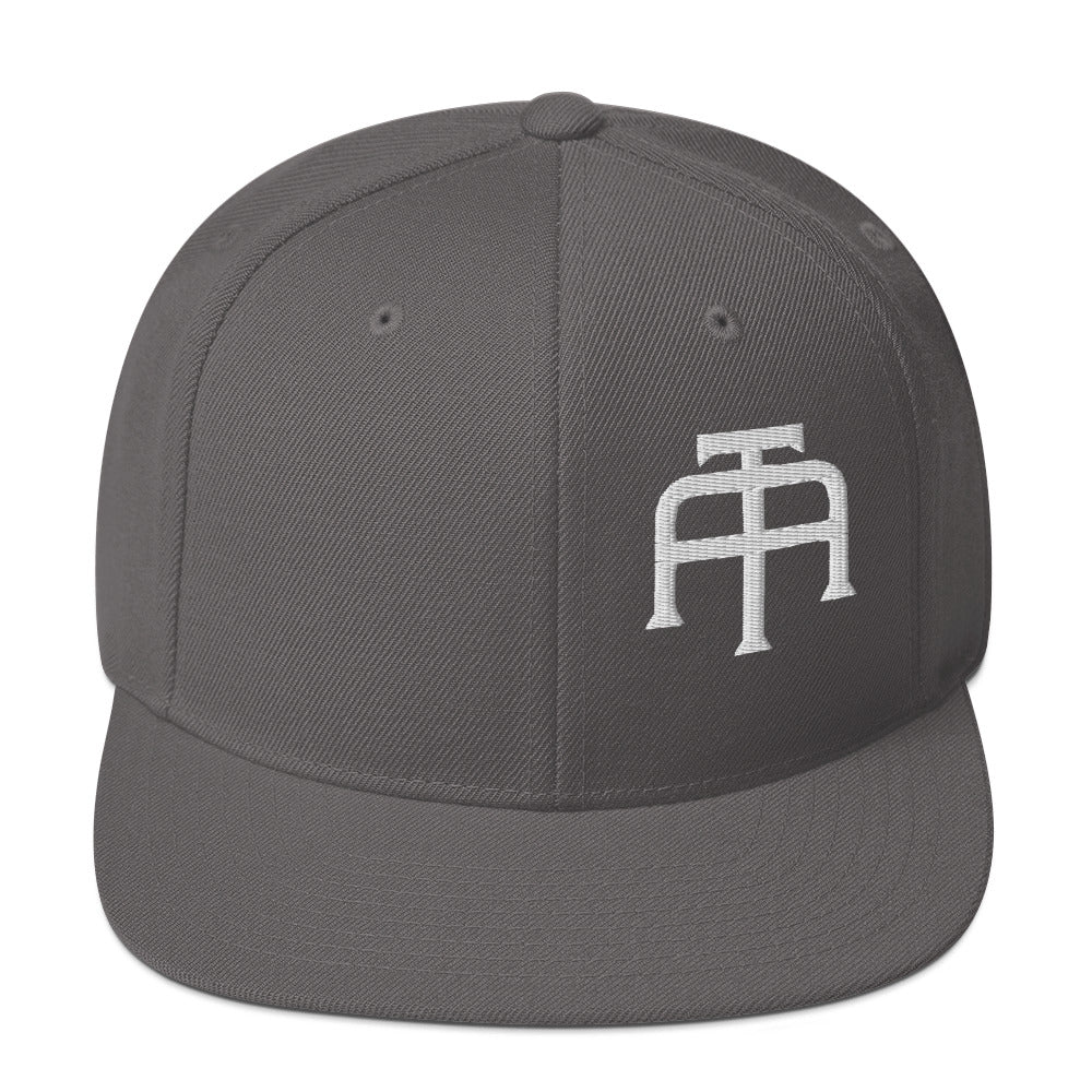 An Athlete Trains structured hat with a classic fit, flat brim, full buckram, and adjustable snap closure.