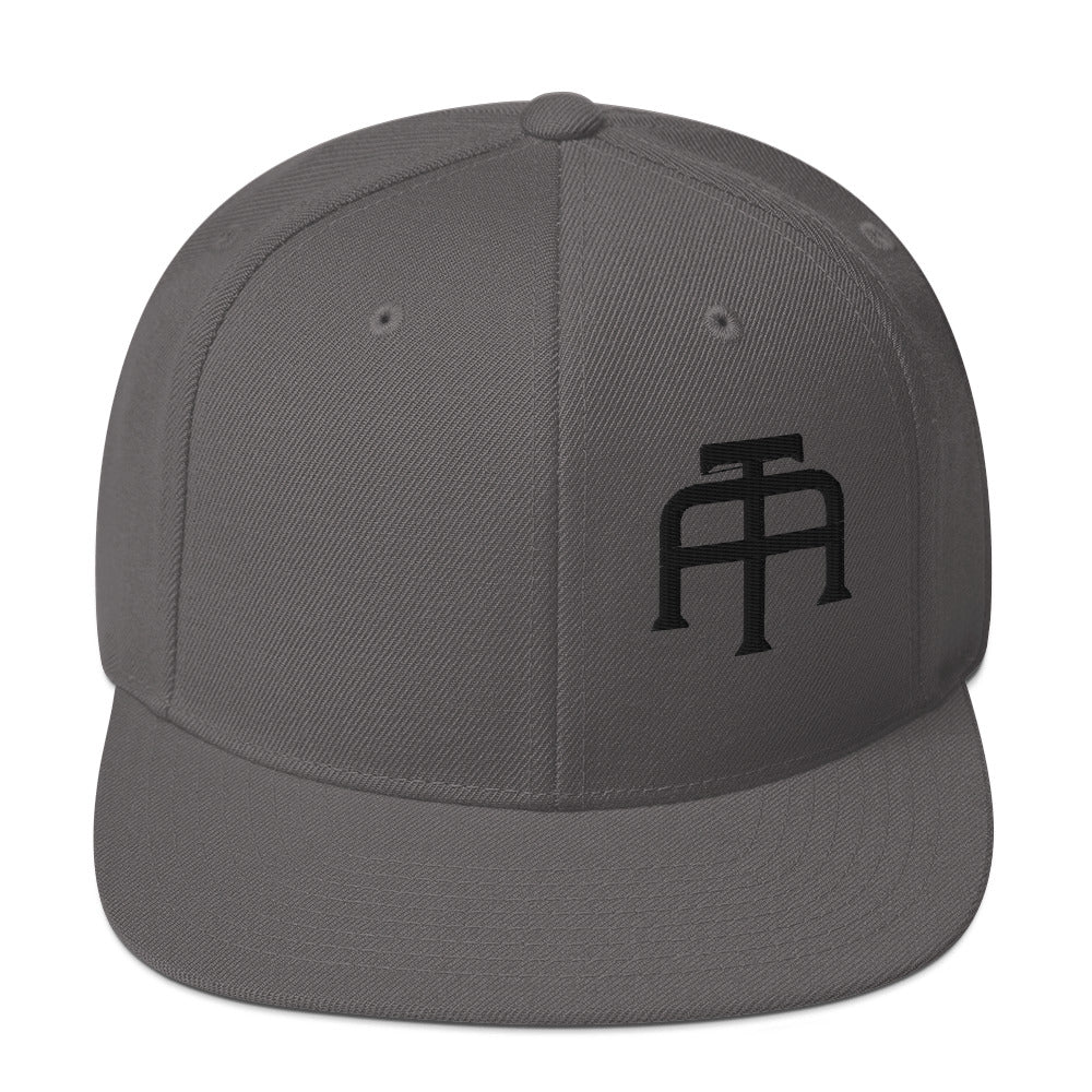 An Athlete Trains structured hat with a classic fit, flat brim, full buckram, and adjustable snap closure.