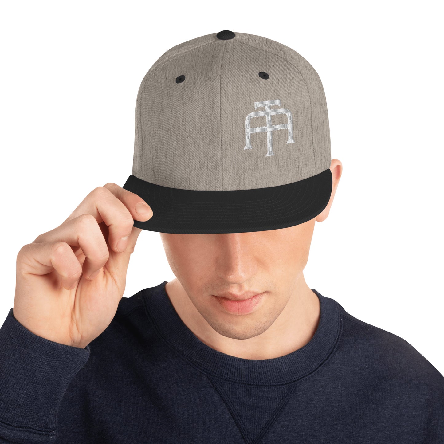 An Athlete Trains structured hat with a classic fit, flat brim, full buckram, and adjustable snap closure.