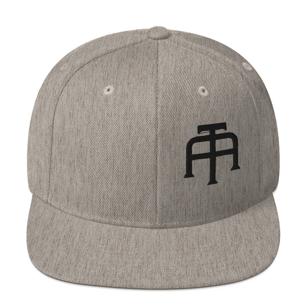 An Athlete Trains structured hat with a classic fit, flat brim, full buckram, and adjustable snap closure.