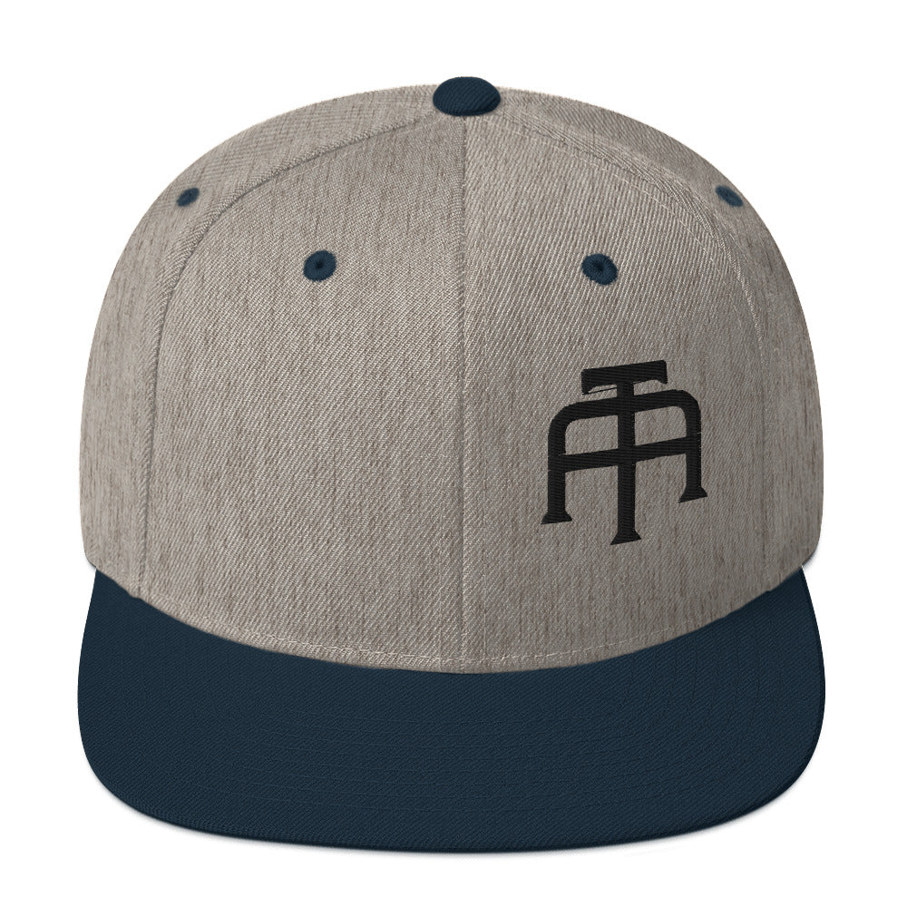 An Athlete Trains structured hat with a classic fit, flat brim, full buckram, and adjustable snap closure.