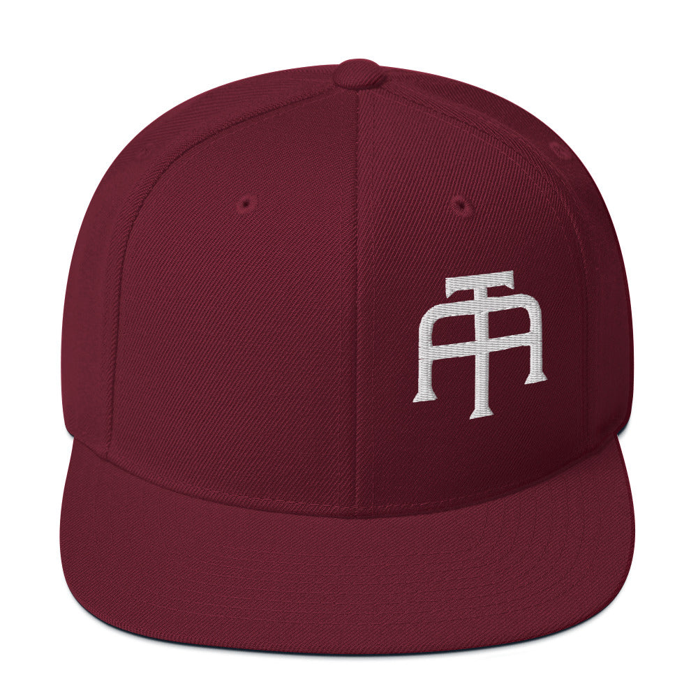 An Athlete Trains structured hat with a classic fit, flat brim, full buckram, and adjustable snap closure.