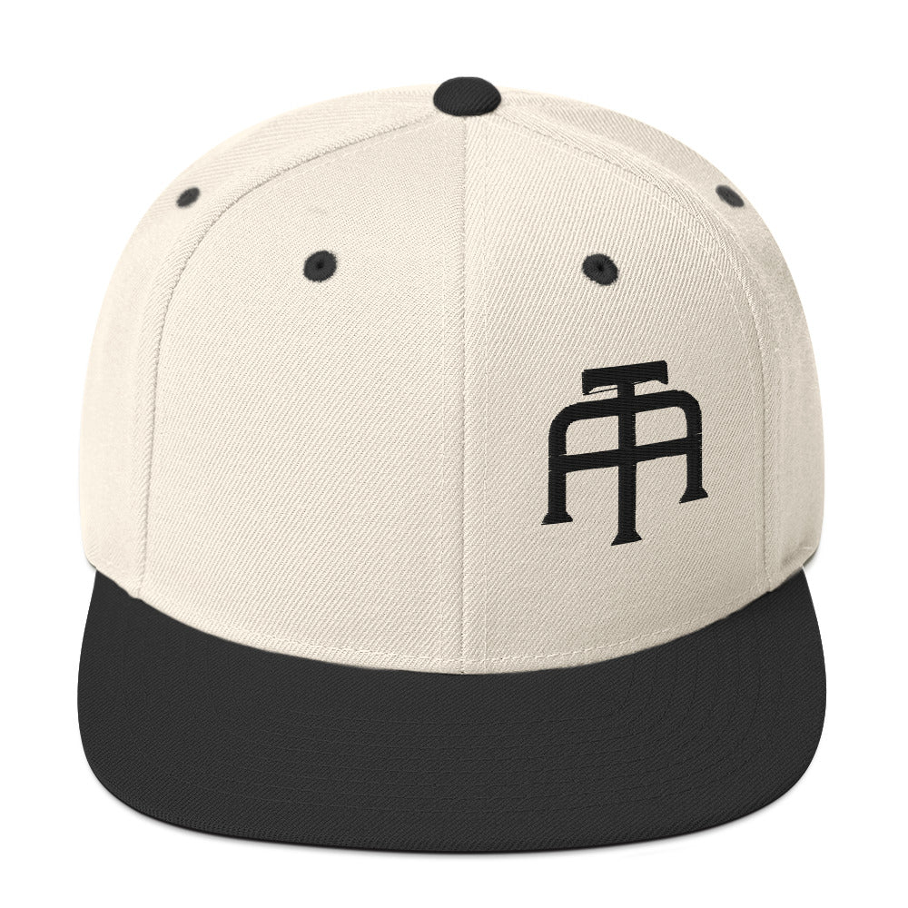 An Athlete Trains structured hat with a classic fit, flat brim, full buckram, and adjustable snap closure.