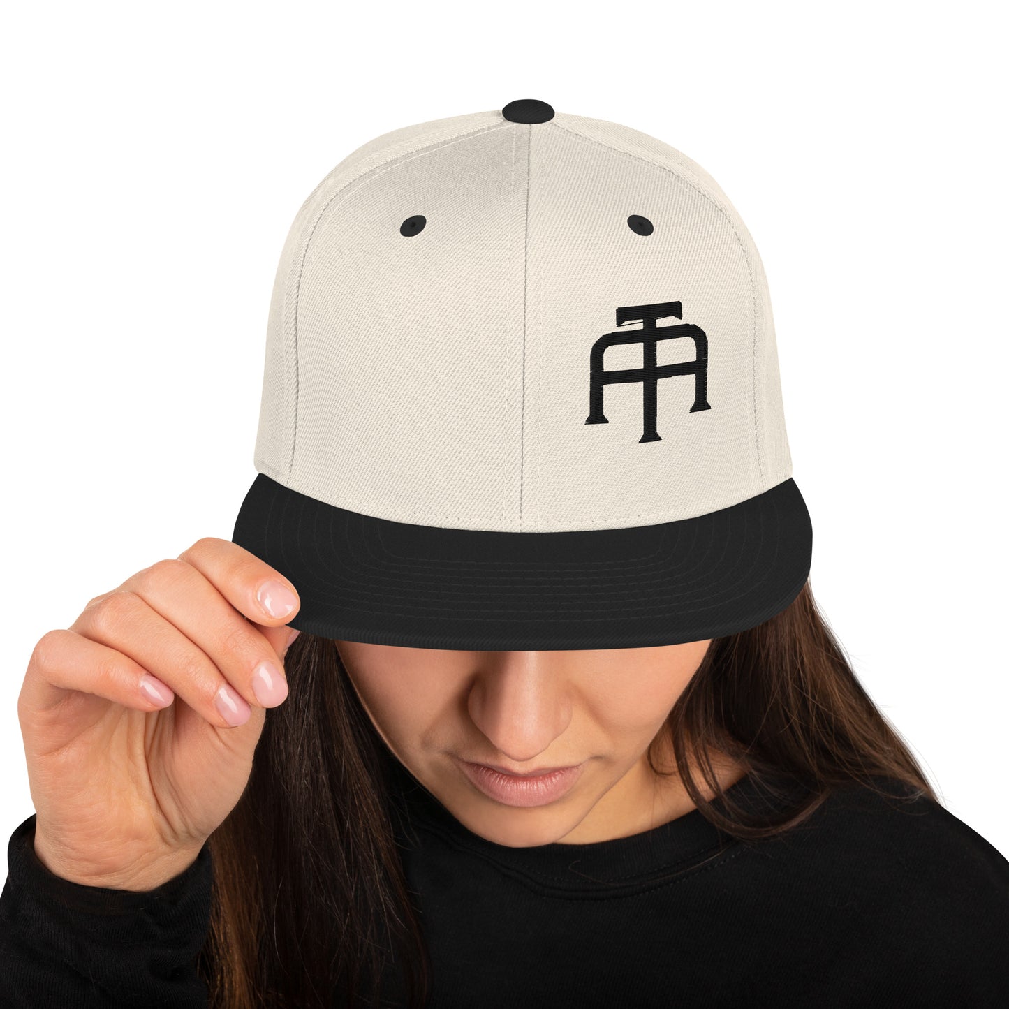 An Athlete Trains structured hat with a classic fit, flat brim, full buckram, and adjustable snap closure.