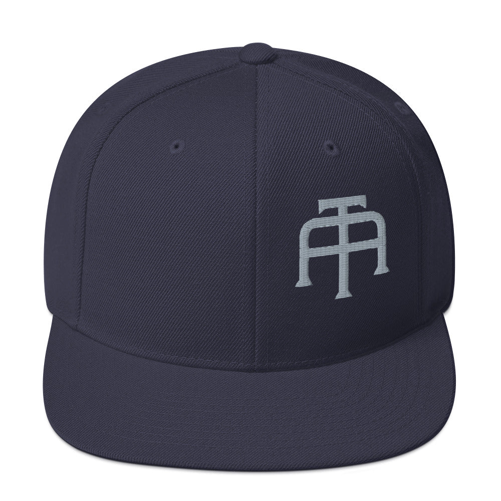 An Athlete Trains structured hat with a classic fit, flat brim, full buckram, and adjustable snap closure.