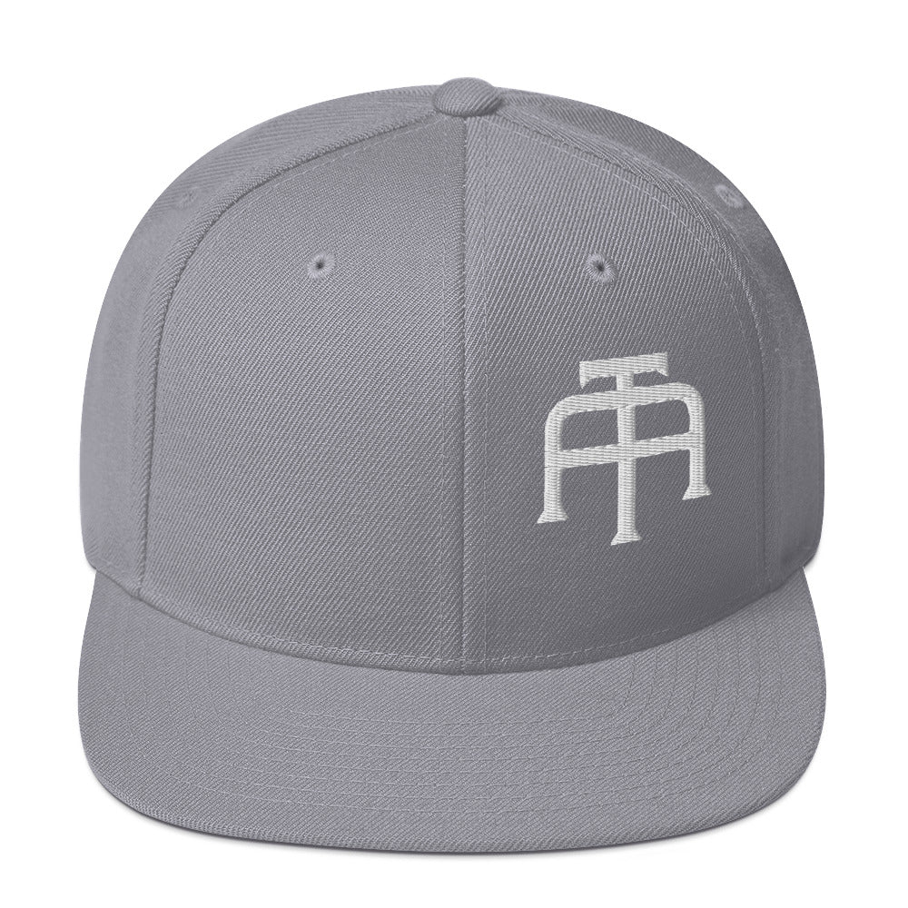 An Athlete Trains structured hat with a classic fit, flat brim, full buckram, and adjustable snap closure.