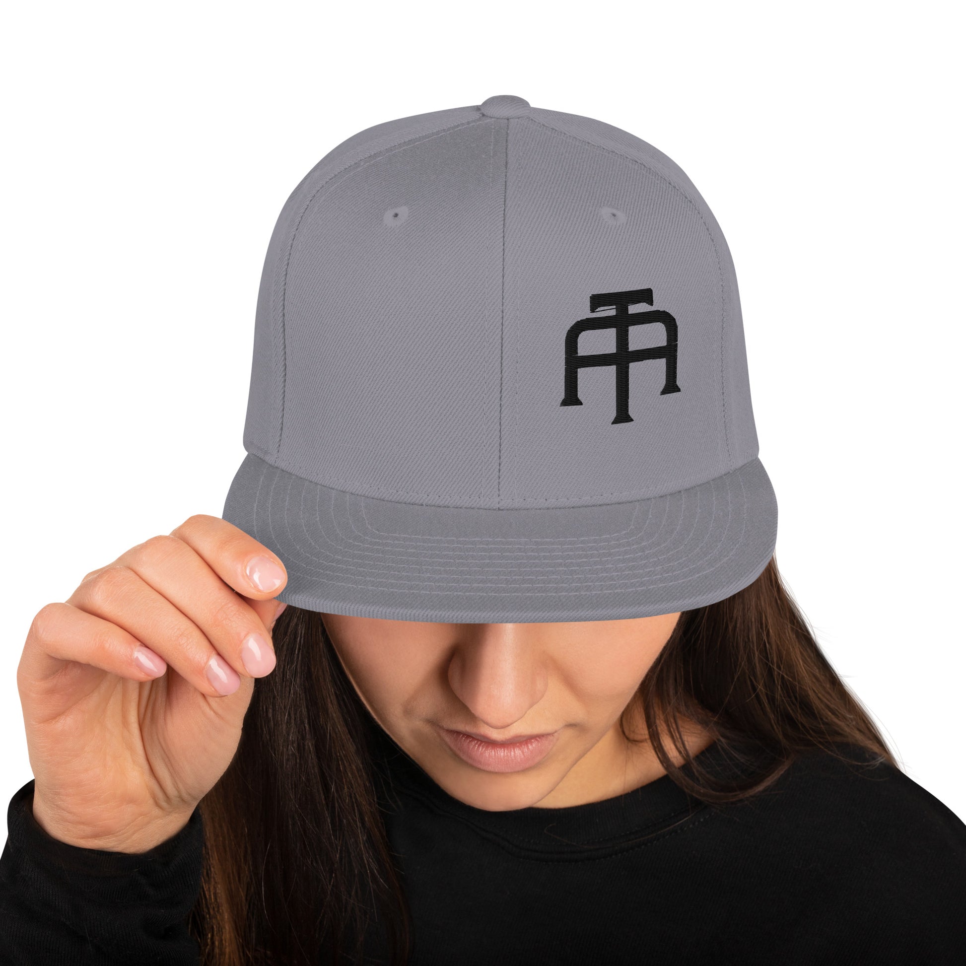 An Athlete Trains structured hat with a classic fit, flat brim, full buckram, and adjustable snap closure.