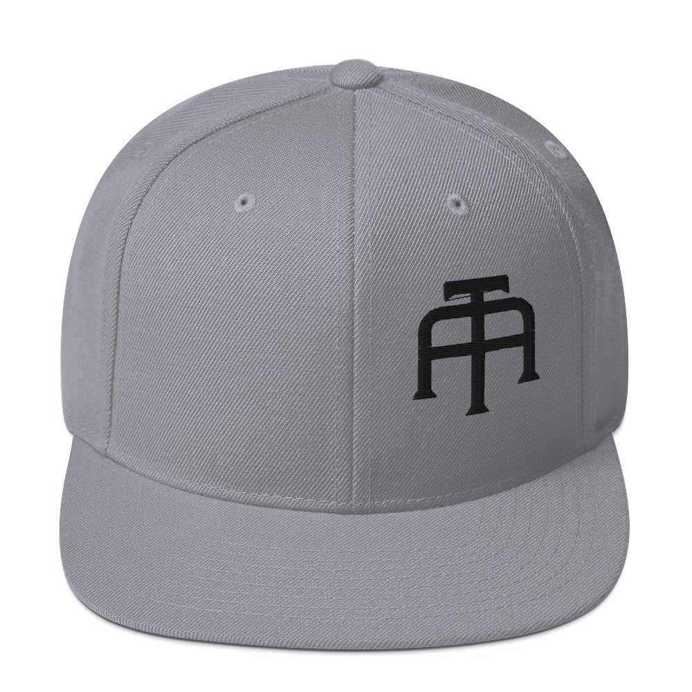 An Athlete Trains structured hat with a classic fit, flat brim, full buckram, and adjustable snap closure.