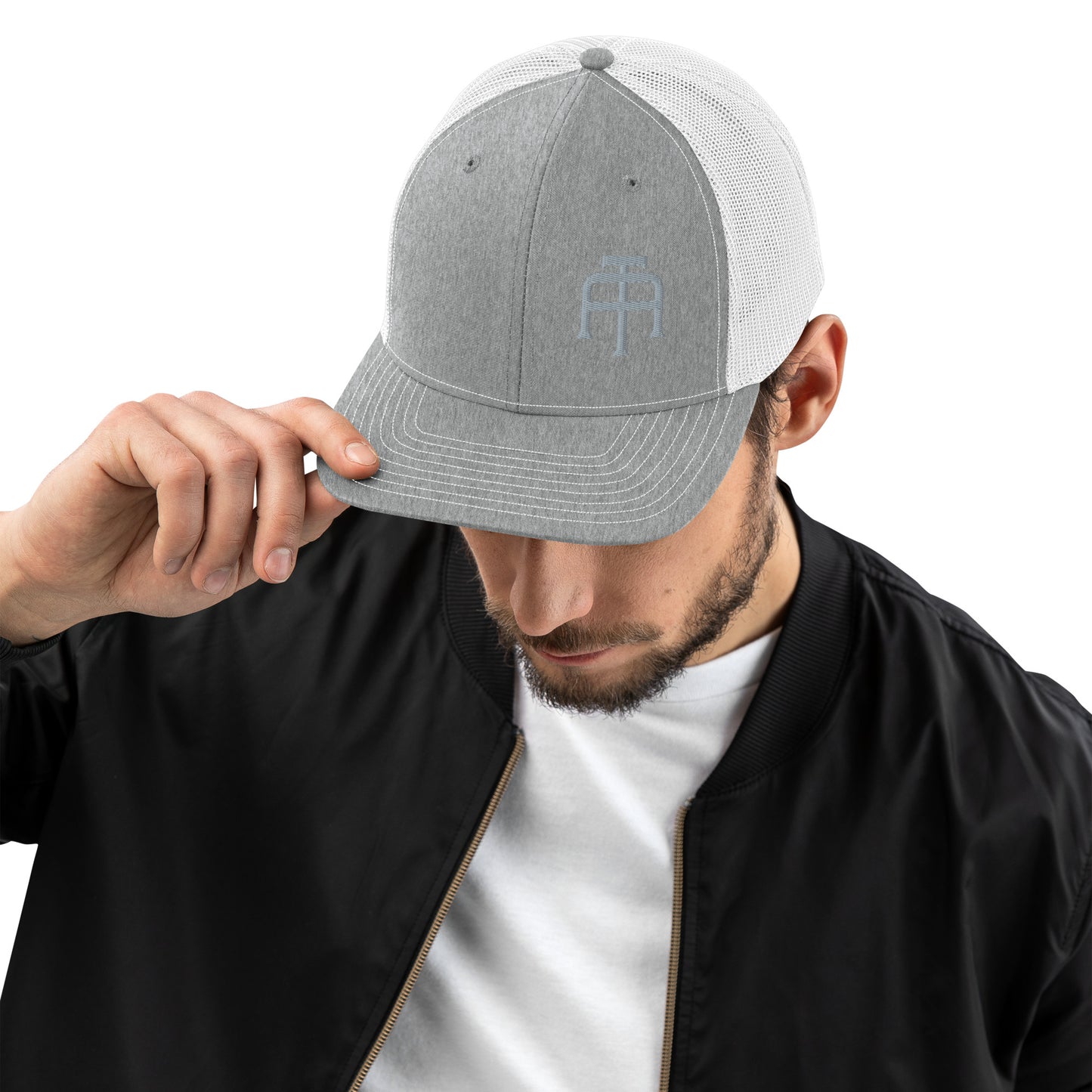 An Athlete Trains structured 6-panel, mid-profile trucker cap is 60% cotton, 40% polyester, 100% polyester mesh back. Pre-curved contrast stitched visor, underbill matches visor color and adjustable plastic snapback