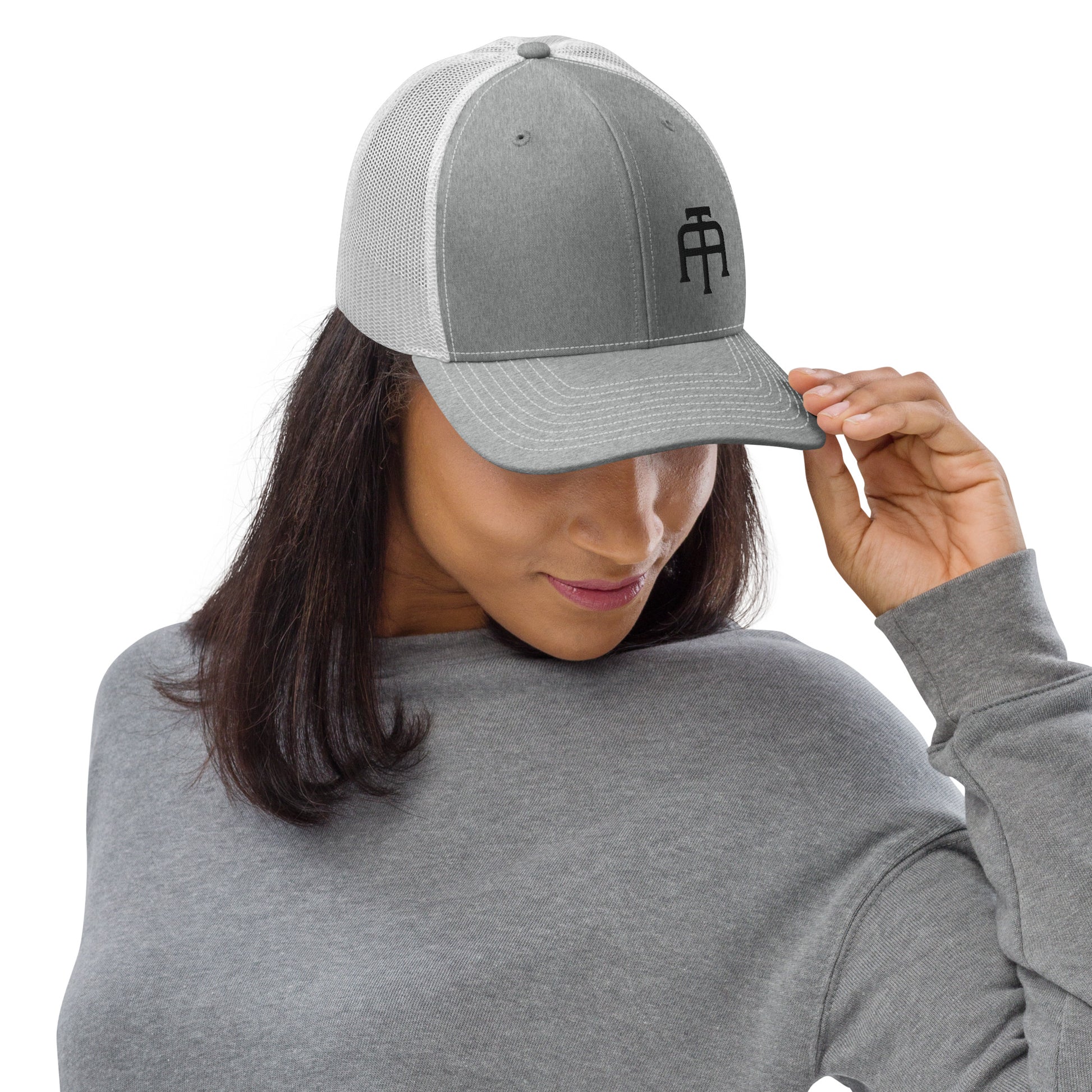 An Athlete Trains structured 6-panel, mid-profile trucker cap is 60% cotton, 40% polyester, 100% polyester mesh back. Pre-curved contrast stitched visor, underbill matches visor color and adjustable plastic snapback