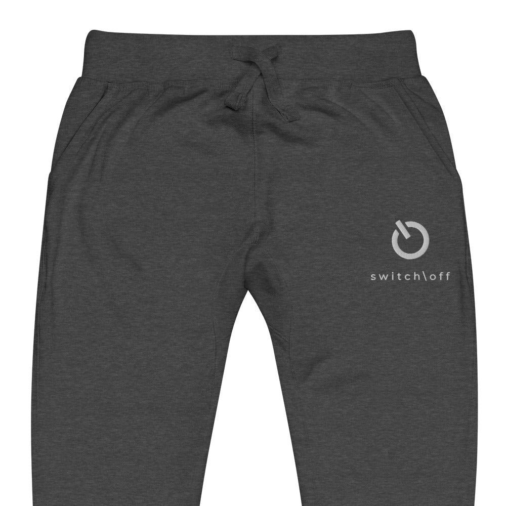 Premium 3-end fleece sweatpants with a soft cotton face in charcoal heather gray with white switch\off and logo embroidery - An Athlete Trains.