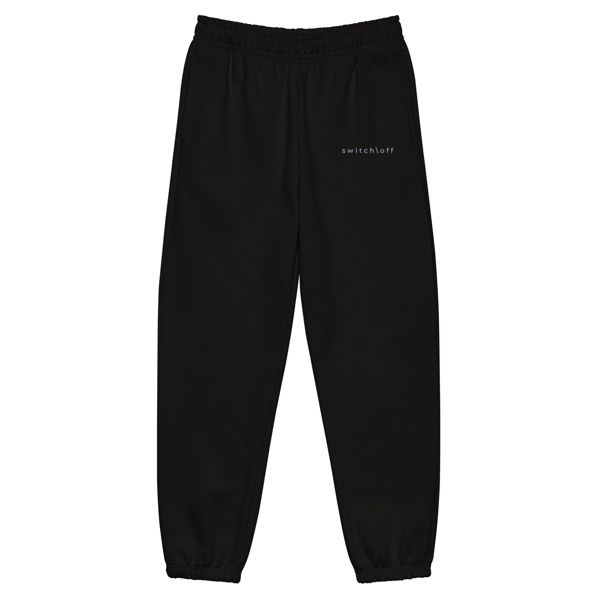 90s style boxy heavyweight sweatpants in black color with gray switch\off embroidery - An Athlete Trains. Front view 