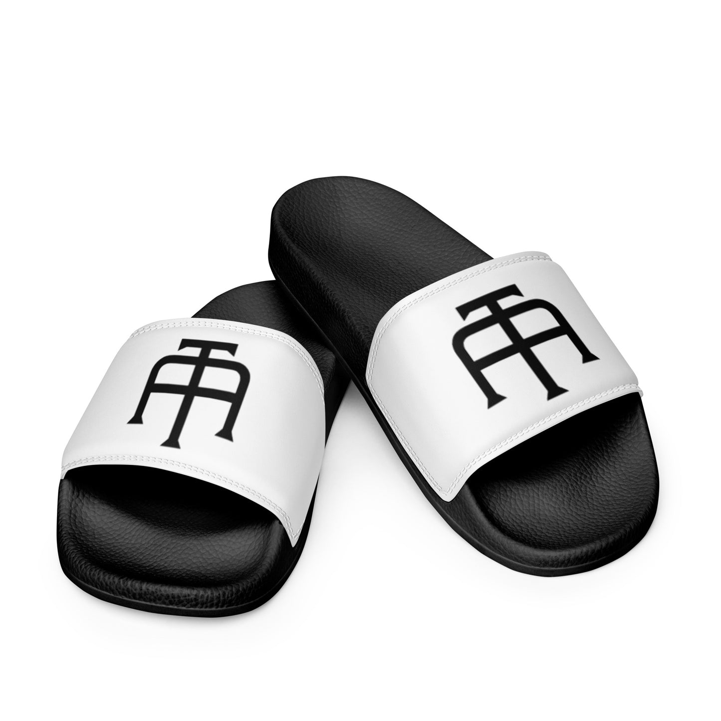 Women’s black slides with cushioned upper strap, textured footbed and a white faux leather upper