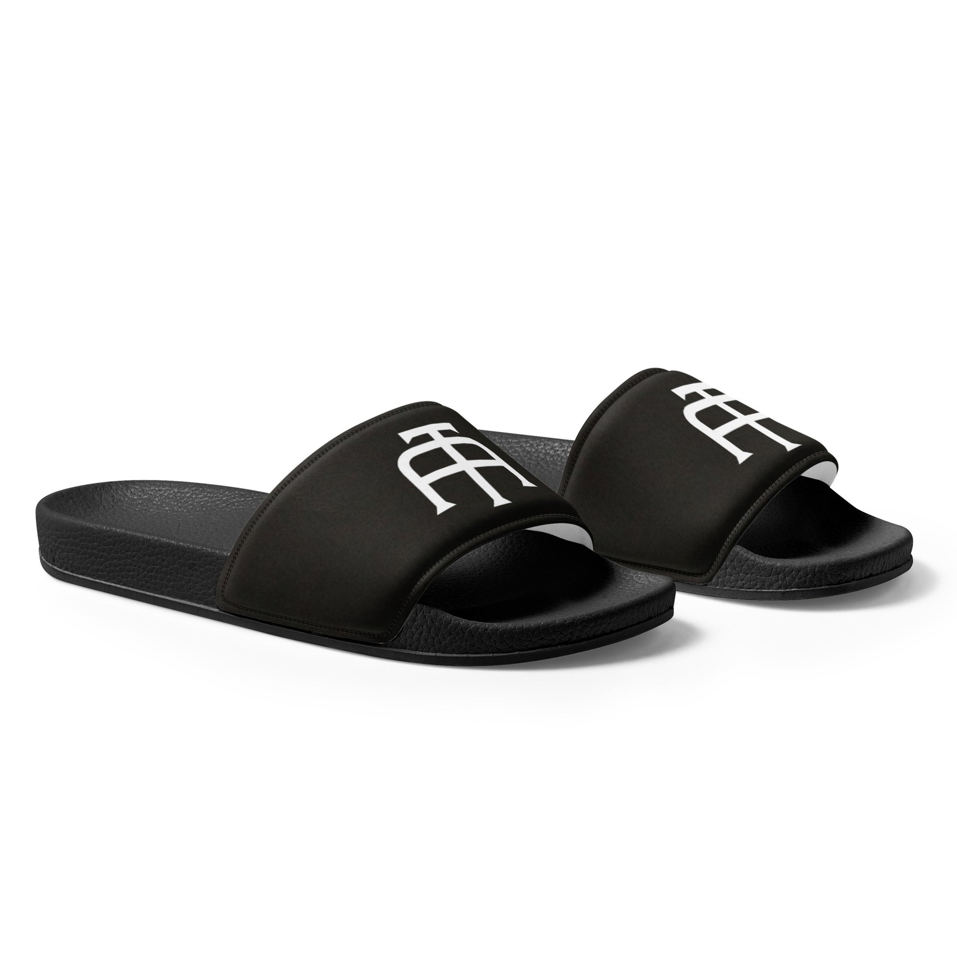 Women’s black slides with cushioned upper strap, textured footbed and a faux leather upper